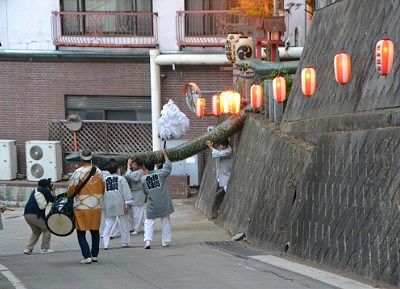 神社の石段を下りてきた大蛇神輿と担ぎ手たち
